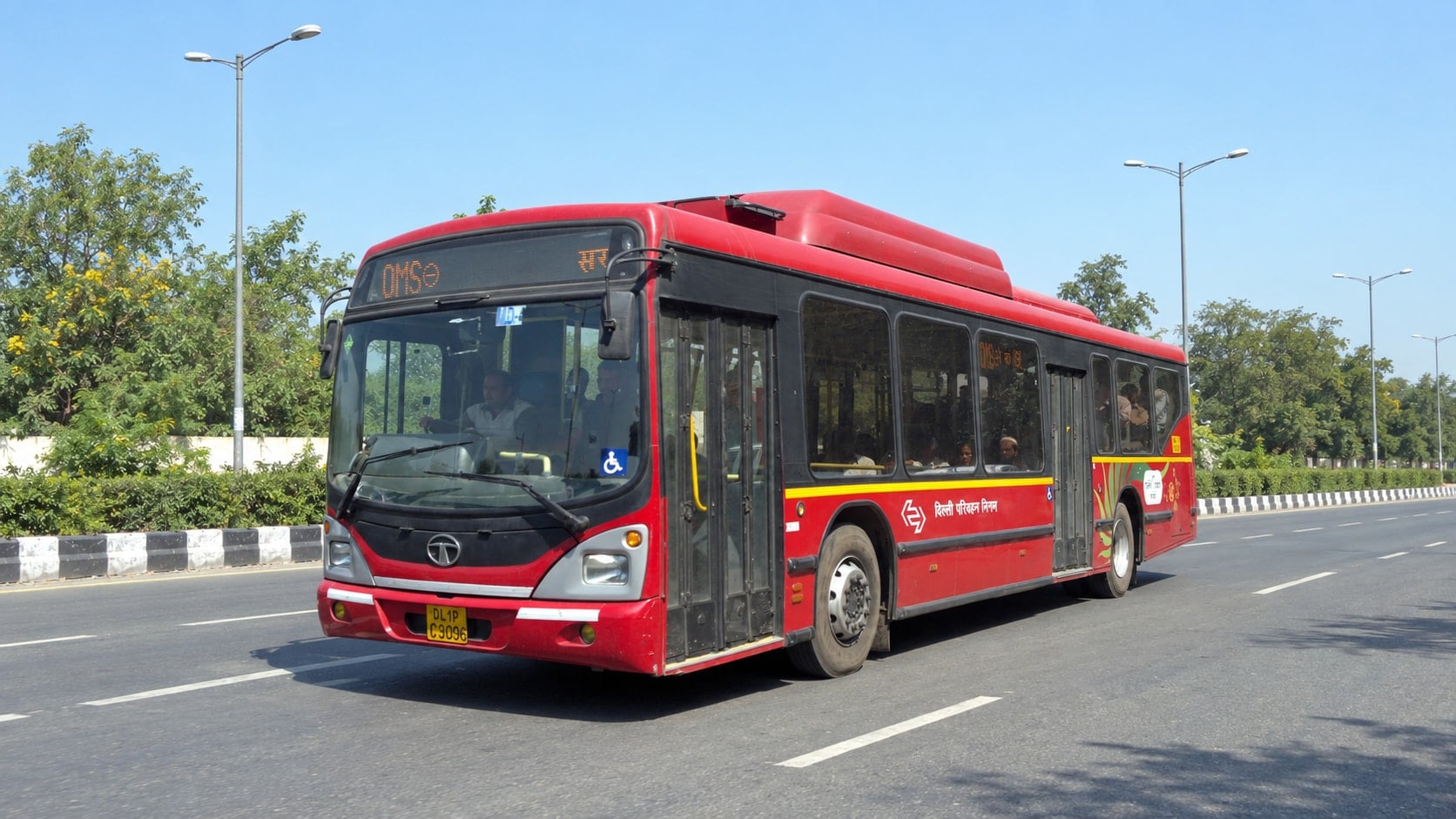 User-supplied photo of a red Tata DTC bus on a road