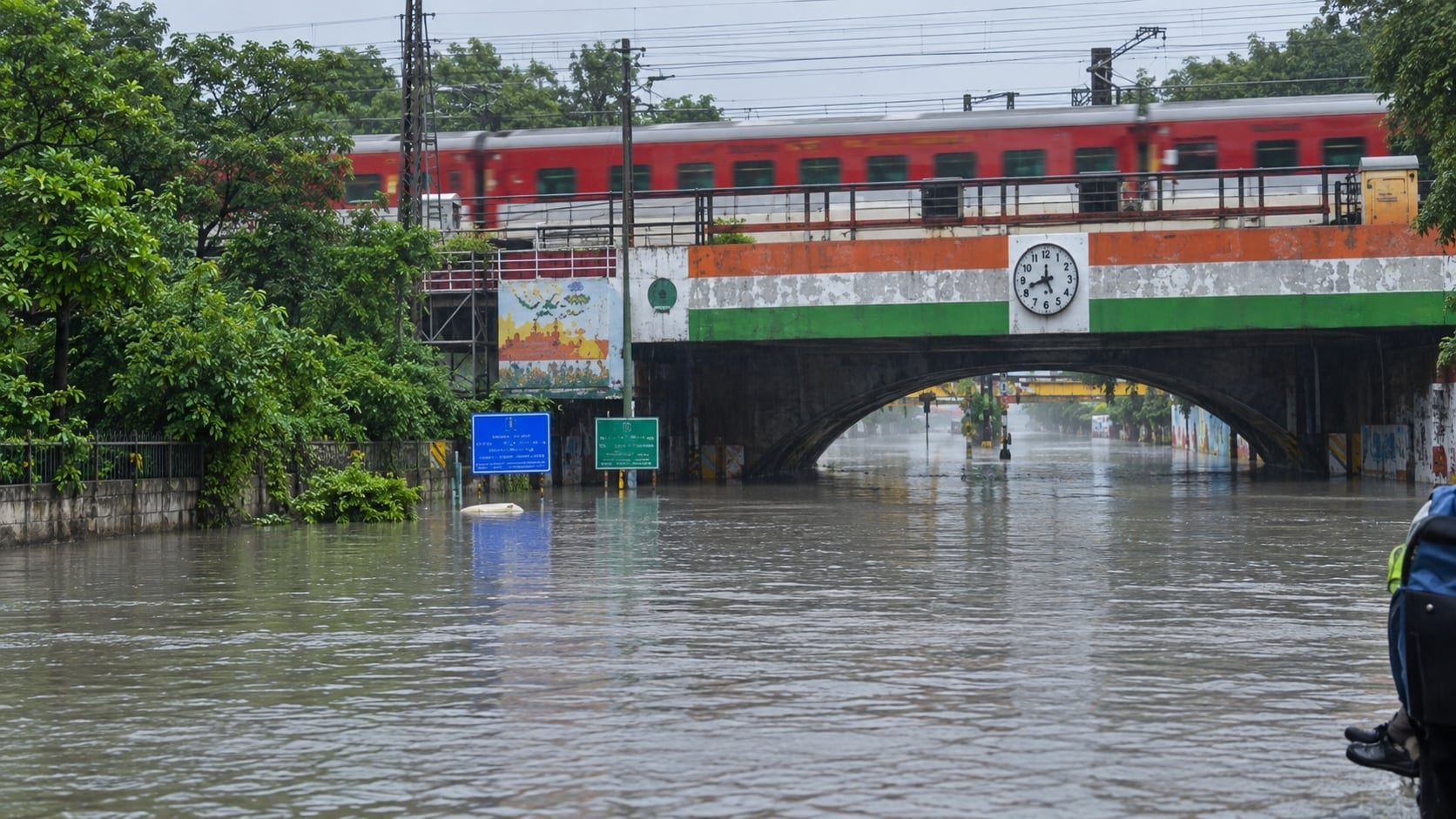User-supplied before view identified as the Minto Bridge underpass, Delhi, flooded up to the road signs with a train crossing above